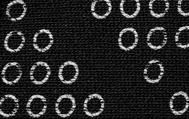 Black cotton fabric with circles pattern texture background.