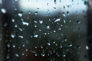 A small raindrop rests on the glass after rain.