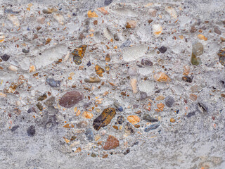 Concrete texture. Macro of a chip on a concrete slab with a micro-texture of cement and gravel. Background for site construction of houses and reconstruction of buildings