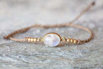 Elegant moon stone bracelet on rocky background