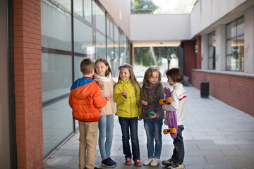 children communicate in school yard in autumn