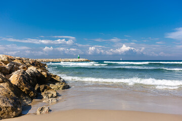 Amazing Mediterranean beach with lighthouse and sailboats  in Tel Aviv Israel.