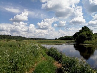 Fototapeta na wymiar river, meadow and clouds
