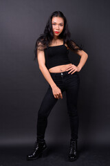 Young beautiful Asian transgender woman against black background