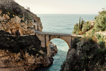 Bridge across the sea and rocks in Amalfi Coast, Italy