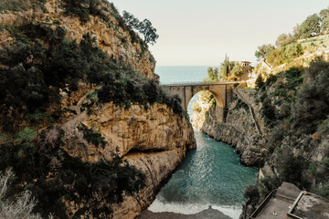 Bridge across the sea and rocks in Amalfi Coast, Italy