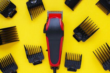 Hair clipper close-up on a yellow background with nozzles of different sizes.