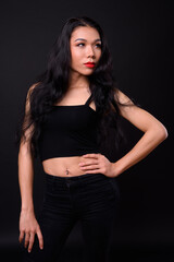 Young beautiful Asian transgender woman against black background
