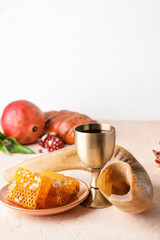 Shofar, sacramental goblet with wine and honey on table. Rosh Hashanah (Jewish New Year) celebration