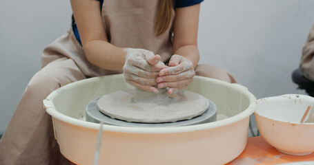 Potter making ceramic pot on the pottery wheel