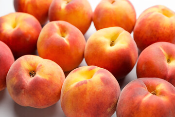 Fototapeta na wymiar Many ripe peaches on light background