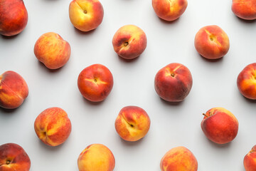 Many ripe peaches on light background
