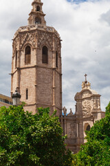 Fototapeta na wymiar Metropolitan Basilica Cathedral of Saint Mary in Valencia with the bell tower El Miquelete. Plaza de la Reina. Spain.