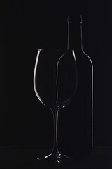 Silhouette bottle of wine and glass