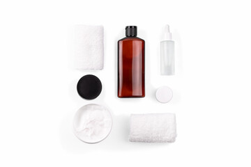 Beautiful spa composition on white in wellness center. Cream, towels, serum in bottle with pipette. Healthy and body care concept. Bath beauty treatment set. Flat lay style. Top view.