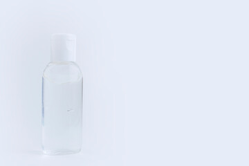 Bottle of instant antiseptic hand sanitizer transparent gel isolated on gray white background, no label. Antibacterial, hydro alcoholic gel, ethyl alcohol. Mini travel pocket small size. Banner.