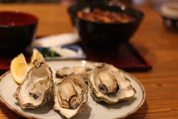Close up of a plate of delicious grilled oysters, Japanese food, Hiroshima, Japan, soft focus