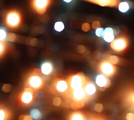 Fototapeta premium Blurred bokeh in warm colors. Lights and highlights for the background.
