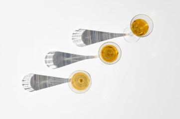 Set of champagne glasses with long shadow behind. Top view minimal on white background