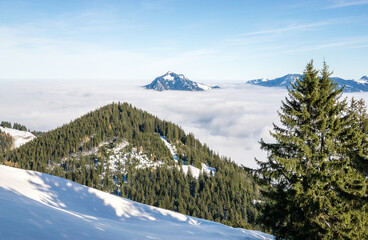 Fototapeta na wymiar Amazing View from Snow Mountain to snowy Mountain Range above inversion foggy cloud layer. Above the clouds on Rangiswangerhorn, Allgau, Bavaria, Germany.