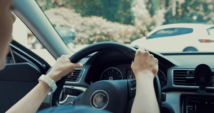 irritated woman screaming, gesturing and honking in car near road with traffic