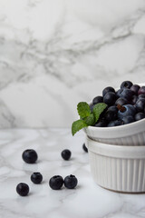 Fresh bluberries with mint in a white bowl