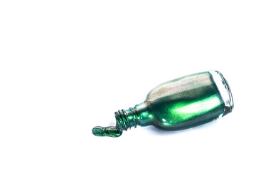 Nail polish flows out of the bottle isolated on white background