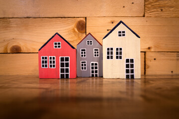 3 pieces of colorful wooden house object that placed on table. Building or Home loan business concept photo.