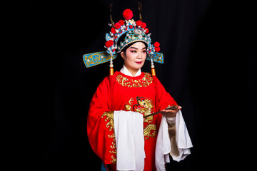 Asian Peking Opera opera actor wearing red costume in black background