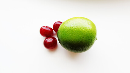 Lime and cherry on a green background