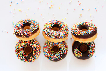 colorful donuts with dark chocolate on white background