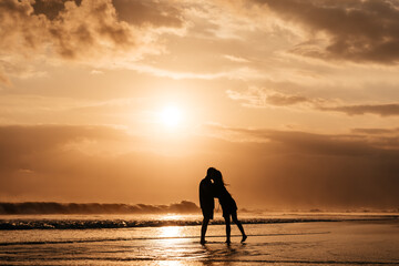 Fototapeta premium Young couple in love, Attractive man and woman enjoying romantic evening on sunset