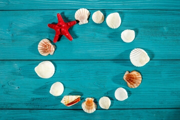 Seashells on a sea sand table in a summer mood