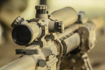 Fototapeta na wymiar High military grade precising rifle scope lens in tan surface color attach on ar marksmanship rifle 