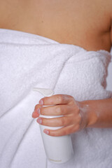Woman pressing the liquid soap to her hand. White soap bottle with dispenser in hand.