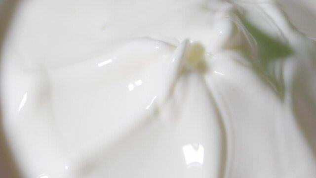Slow Motion Shot of Splashing milk in bright light. Macro close up footage. Milk texture. For use in recipe and food projects.
