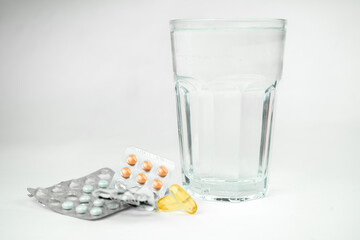 omega 3 fish oil big gel capsules, pills and glass of water, healthcare, vitamins