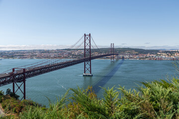 Bridge on April 25 in Lisbon on the Tejo river with moving cars.