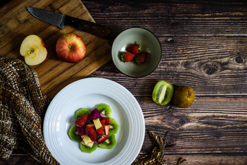 Fruit salad, mixed fruit in a white plate, strawberry, kiwi, apple