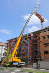 High crane at the construction of a new apartment building