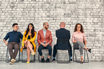 Corporate employees. Business matters discussion. Solid team ignoring lonely colleague.