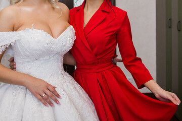 bride in wedding dress with bridesmaid in studio