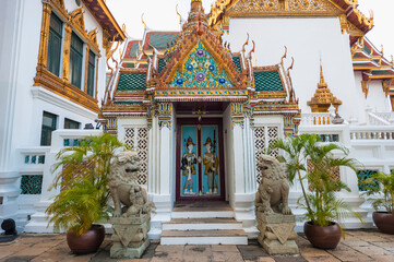 Fototapeta premium Ancient guards on a doors relief, Grand Palace, Bangkok, Thailand