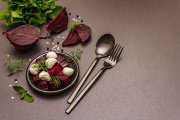 Culinary background. Cooking food concept. Healthy salad with baked beetroot, baby mozzarella, fresh greens