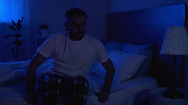 Male sleepwalker in bedroom at night