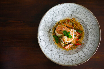 Spicy salad with shrimp and chili paste on table wood . Cooking thai food concept.