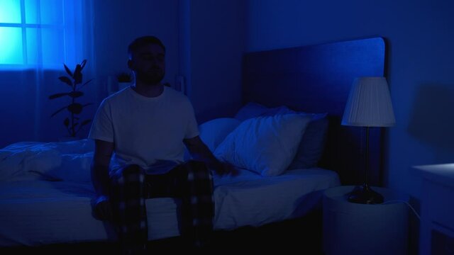 Male sleepwalker in bedroom at night