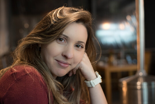 Woman With Subtle Smile In A Restaurant