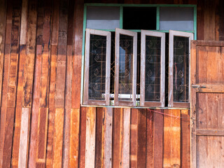 Naklejka na ściany i meble Wall of Wooden House, Windows with Wrought Iron