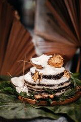 Brazilian traditional dessert: sweet couscous tapioca pudding cuscuz doce with coconut on wooden board. Selective focus